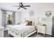Spacious bedroom with white bed and ceiling fan at 1398 Shady Pine Way # E3, Tarpon Springs, FL 34688