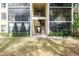 Two-story building with screened balconies and landscaping at 1398 Shady Pine Way # E3, Tarpon Springs, FL 34688