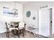 Dining area with a wooden table and white chairs at 1398 Shady Pine Way # E3, Tarpon Springs, FL 34688