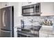 Sleek kitchen with stainless steel appliances and granite countertops at 1398 Shady Pine Way # E3, Tarpon Springs, FL 34688