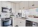 Modern kitchen with stainless steel appliances and granite countertops at 1398 Shady Pine Way # E3, Tarpon Springs, FL 34688