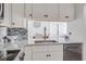 Modern kitchen with white cabinets and granite countertops at 1398 Shady Pine Way # E3, Tarpon Springs, FL 34688