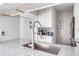 Kitchen features a modern sink and faucet with granite countertops at 1398 Shady Pine Way # E3, Tarpon Springs, FL 34688