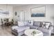 Living area featuring a gray sectional and coastal decor at 1398 Shady Pine Way # E3, Tarpon Springs, FL 34688