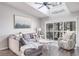 Living room featuring a gray sectional sofa and coastal decor at 1398 Shady Pine Way # E3, Tarpon Springs, FL 34688