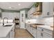 Modern kitchen with white cabinets, stainless steel appliances and subway tile backsplash at 14214 Quintessa Ln, Lithia, FL 33547