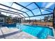 Screened pool and spa with extended patio overlooking the landscape at 14214 Quintessa Ln, Lithia, FL 33547