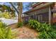 Stone patio and screened porch in a private backyard setting at 1455 Briarwood Ct, Safety Harbor, FL 34695