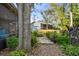 Landscaped backyard with flagstone patio, lush greenery, and mature trees at 1455 Briarwood Ct, Safety Harbor, FL 34695