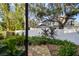 Landscaped backyard with flagstone patio and lush greenery at 1455 Briarwood Ct, Safety Harbor, FL 34695