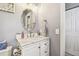Vanity with marble countertop and oval mirror at 1455 Briarwood Ct, Safety Harbor, FL 34695