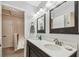 Modern bathroom with double sinks and updated light fixtures at 1455 Briarwood Ct, Safety Harbor, FL 34695