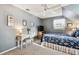 Serene bedroom with a ceiling fan, TV, and ample natural light at 1455 Briarwood Ct, Safety Harbor, FL 34695
