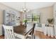 Bright dining area with farmhouse table, built in window seat, and china cabinet at 1455 Briarwood Ct, Safety Harbor, FL 34695