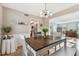 Dining area with table, chairs, bench and kitchen access at 1455 Briarwood Ct, Safety Harbor, FL 34695