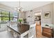 Dining room with table, chairs, built-in bench, and kitchen view at 1455 Briarwood Ct, Safety Harbor, FL 34695