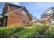 House exterior showcasing wood siding, landscaping, and a spacious yard at 1455 Briarwood Ct, Safety Harbor, FL 34695