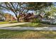 House exterior showcasing wood siding and mature tree at 1455 Briarwood Ct, Safety Harbor, FL 34695