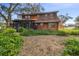 Back exterior of house with large yard and screened porch at 1455 Briarwood Ct, Safety Harbor, FL 34695