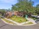 Two-story home with wood siding, mature landscaping, and a driveway at 1455 Briarwood Ct, Safety Harbor, FL 34695