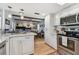 Modern kitchen with stainless steel appliances and an island at 1455 Briarwood Ct, Safety Harbor, FL 34695