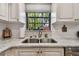 Kitchen features a farmhouse sink and updated cabinetry at 1455 Briarwood Ct, Safety Harbor, FL 34695