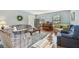 Living room with hardwood floors, sofas, and a piano at 1455 Briarwood Ct, Safety Harbor, FL 34695