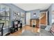 Home office with a roll top desk, gray couch, and built-in shelving at 1455 Briarwood Ct, Safety Harbor, FL 34695