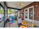 Screened porch with rocking chair and outdoor seating at 1455 Briarwood Ct, Safety Harbor, FL 34695