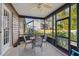 Screened porch with table and chairs, great for outdoor dining at 1455 Briarwood Ct, Safety Harbor, FL 34695