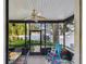 Relaxing screened porch with seating and ceiling fan at 1455 Briarwood Ct, Safety Harbor, FL 34695