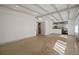 Living room with exposed beams, terrazzo floor, and kitchen view at 1916 E Clinton St, Tampa, FL 33610