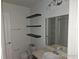 Bathroom with sink, toilet, and floating shelves at 2566 Sea Wind Way, Clearwater, FL 33763