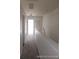 Upstairs hallway with light walls and carpeting at 2566 Sea Wind Way, Clearwater, FL 33763