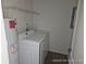 Laundry room with washer, dryer, and shelving at 2566 Sea Wind Way, Clearwater, FL 33763