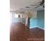 Living room with hardwood floors, stairs, and teal walls at 2566 Sea Wind Way, Clearwater, FL 33763
