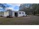 Gray metal storage shed with a side door, offering ample storage space at 26341 Dayflower Blvd, Wesley Chapel, FL 33544