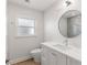 Bathroom featuring a modern vanity, round mirror, sleek fixtures, and neutral tile accents at 280 N Julia Cir, St Pete Beach, FL 33706