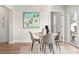 Bright dining area with modern chandelier, stylish table set, and a decorative art piece at 280 N Julia Cir, St Pete Beach, FL 33706