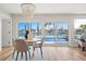 A bright dining area with a waterfront view and sliding glass doors to a private pool at 280 N Julia Cir, St Pete Beach, FL 33706