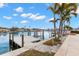 Dock and waterfront view features a wooden dock and walkway, with lush landscaping and waterfront views at 280 N Julia Cir, St Pete Beach, FL 33706
