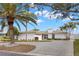 Exterior shot of a modern home showcasing a well-maintained lawn and circular driveway at 280 N Julia Cir, St Pete Beach, FL 33706