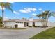 Modern single-story home with paved driveway and palm trees at 280 N Julia Cir, St Pete Beach, FL 33706