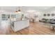 The open-concept kitchen features stainless steel appliances, a central island, and modern lighting fixtures at 280 N Julia Cir, St Pete Beach, FL 33706