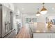 The modern kitchen features stainless steel appliances and a spacious island with counter seating at 280 N Julia Cir, St Pete Beach, FL 33706