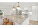 Island kitchen with granite counters, pendant lights, stainless appliances, and barstool seating at 280 N Julia Cir, St Pete Beach, FL 33706