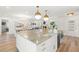 The open-concept kitchen features stainless steel appliances, a central island, and modern lighting fixtures at 280 N Julia Cir, St Pete Beach, FL 33706