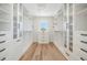 Spacious walk-in closet with custom shelving, drawers and window with neighborhood views at 280 N Julia Cir, St Pete Beach, FL 33706