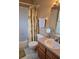 Clean bathroom with shower/tub combo and wood vanity at 30119 Wellesley Way, Wesley Chapel, FL 33543