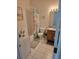 Bathroom with tub shower and wood vanity at 30119 Wellesley Way, Wesley Chapel, FL 33543